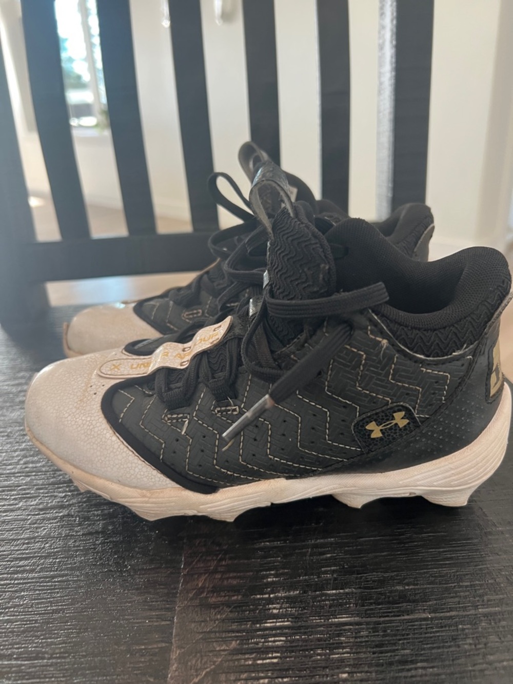 Under Armour Kids Black and White Athletic Sneakers with Gold Accents
